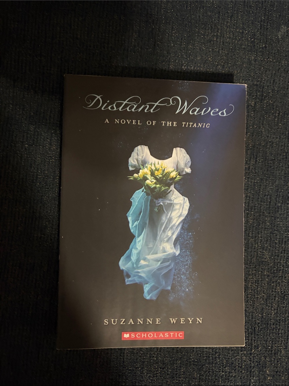 Scholastic Distant Waves Paperback - Black Cover with Blue and White Dress Art
